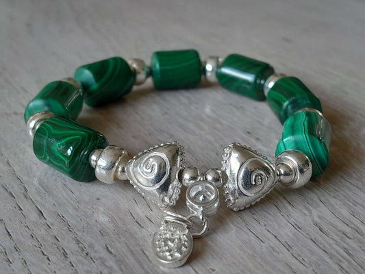 Beautiful Malachite bracelet with sterling silver accents, showcasing vibrant green stones and elegant design.